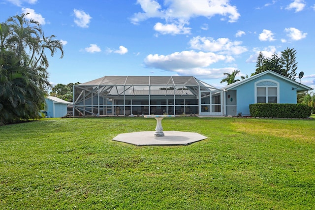 back of property featuring a lanai and a lawn