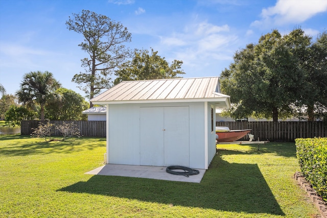 view of outdoor structure featuring a lawn