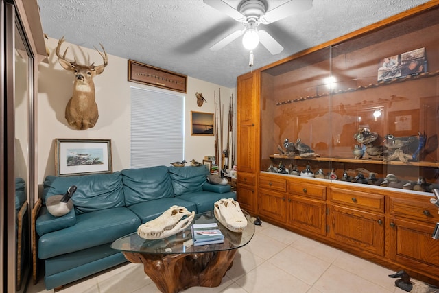 5609 SE Lamay Dr, Stuart, FL 34997 - living room featuring a textured ceiling, light tile patterned floors, and ceiling fan