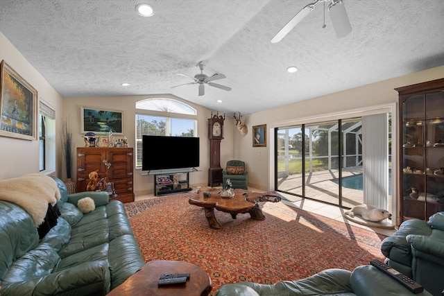 5609 SE Lamay Dr, Stuart, FL 34997 - living room with ceiling fan, lofted ceiling, a textured ceiling, plenty of natural light, and recessed lighting