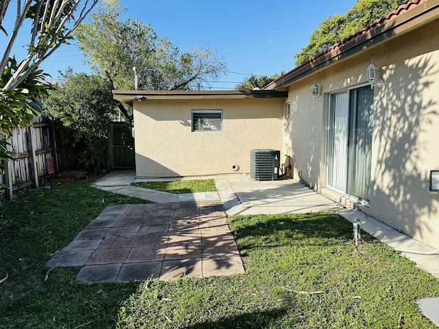 view of yard featuring a patio area, cooling unit, and fence