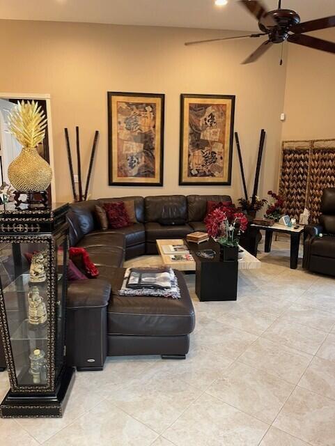 living room with ceiling fan and light tile patterned floors