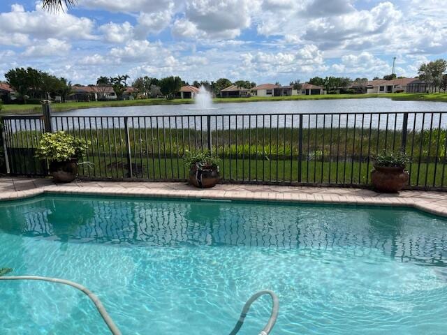 view of swimming pool featuring a water view