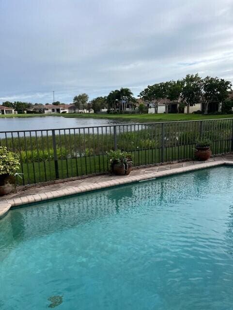 view of pool featuring a water view