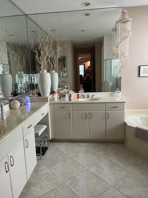 bathroom with tile patterned floors, vanity, and a washtub