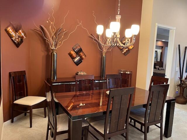 carpeted dining space with a notable chandelier