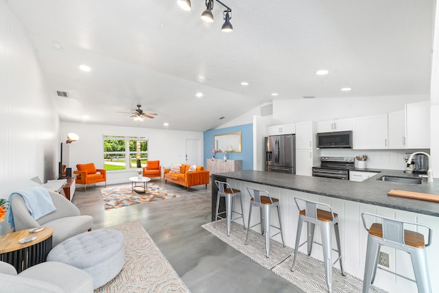 interior space featuring lofted ceiling, sink, and ceiling fan