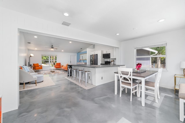 dining area with a wealth of natural light, vaulted ceiling, and ceiling fan