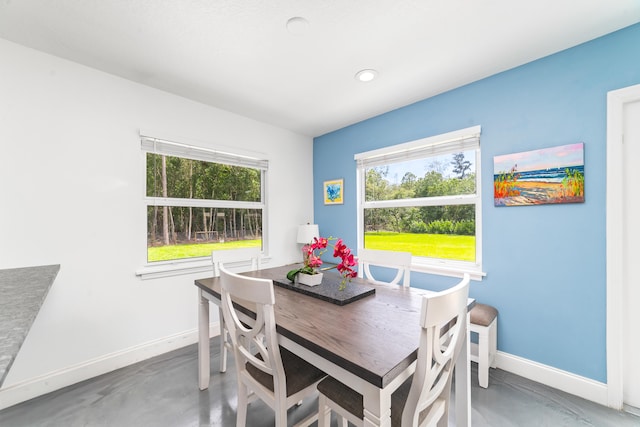 dining area featuring concrete floors