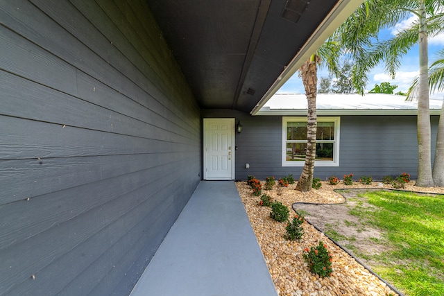 view of exterior entry featuring a yard