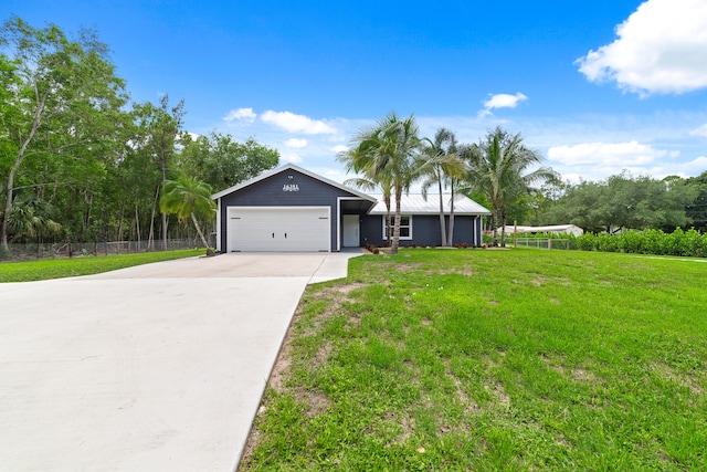 ranch-style home featuring a front yard and a garage