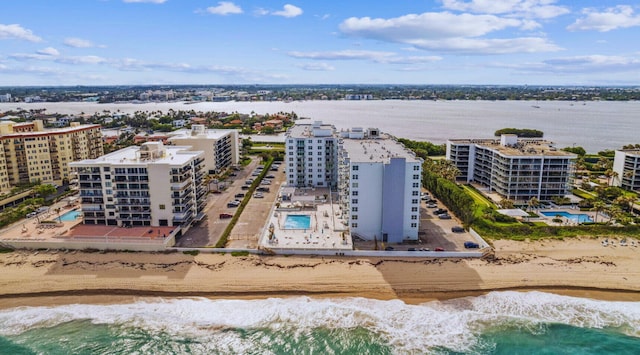 bird's eye view featuring a water view and a view of the beach