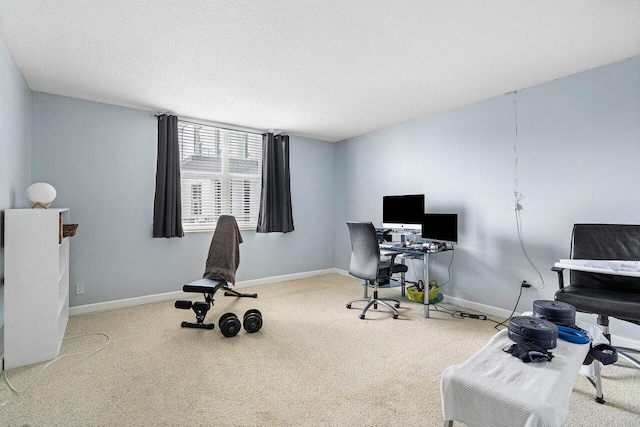 home office with a textured ceiling and carpet flooring