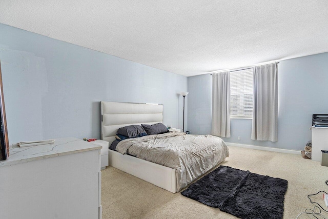 carpeted bedroom featuring a textured ceiling