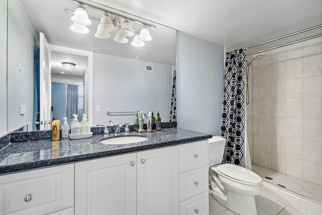 bathroom with vanity, toilet, tile patterned floors, and a shower with shower curtain