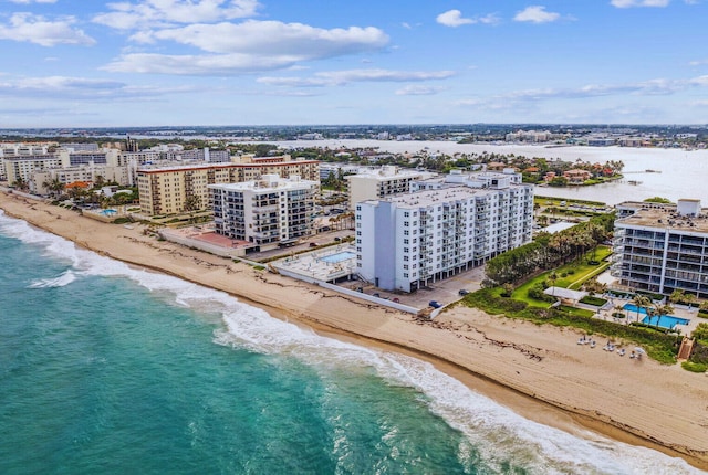 drone / aerial view featuring a water view and a view of the beach