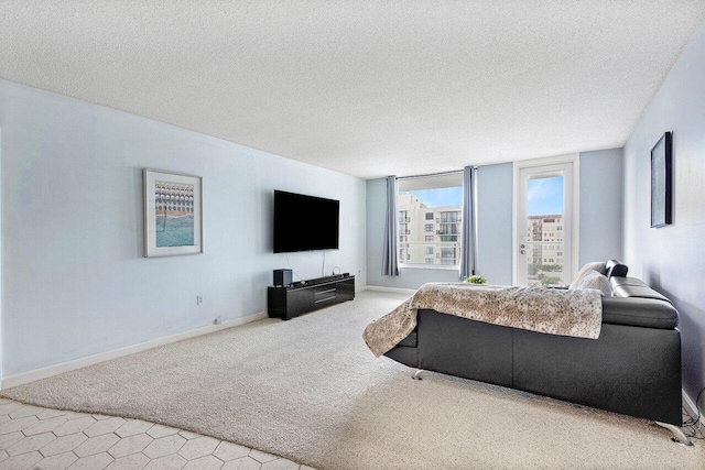 carpeted living room featuring a textured ceiling