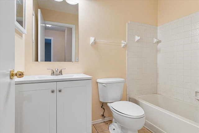 full bathroom featuring toilet, tiled shower / bath, vanity, and tile patterned floors