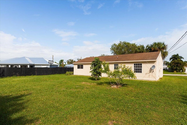 rear view of property with a yard