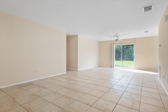 spare room with ceiling fan and light tile patterned floors