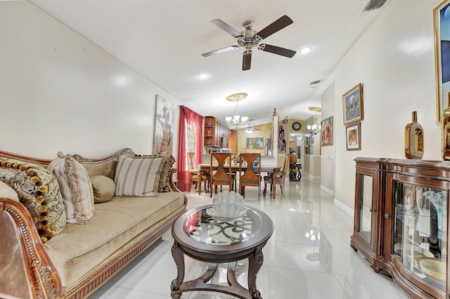 living room featuring light tile patterned floors, a textured ceiling, vaulted ceiling, and ceiling fan with notable chandelier