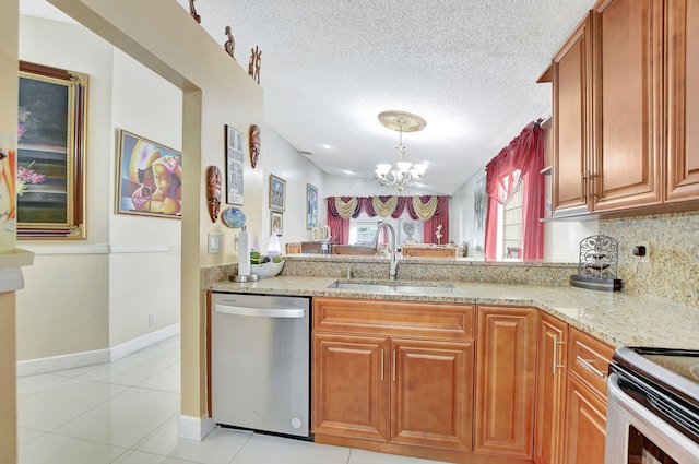 kitchen featuring a notable chandelier, a textured ceiling, stainless steel appliances, and sink