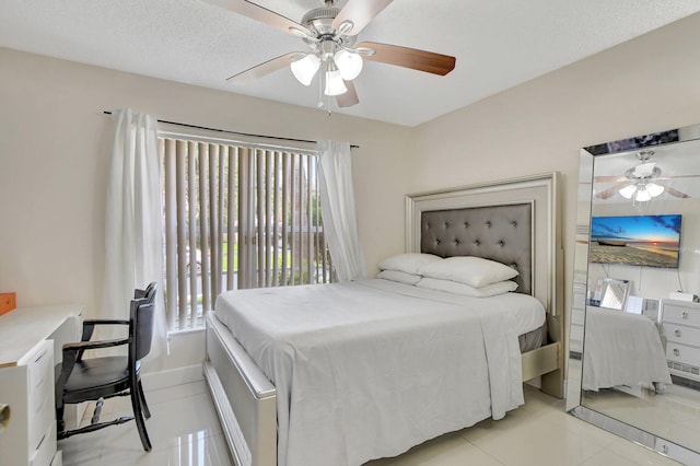 tiled bedroom with a textured ceiling, multiple windows, and ceiling fan