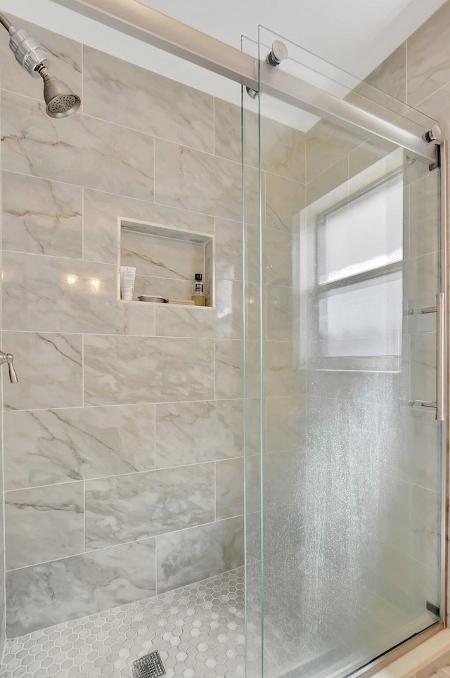 bathroom with a shower with shower door