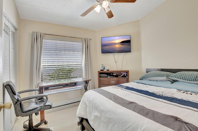 bedroom with a closet, ceiling fan, and a textured ceiling