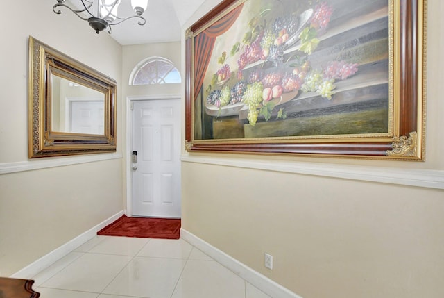 doorway to outside featuring light tile patterned flooring and a notable chandelier