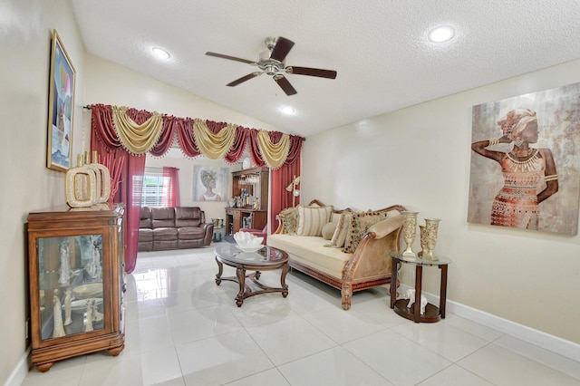 tiled living room featuring vaulted ceiling, a textured ceiling, and ceiling fan