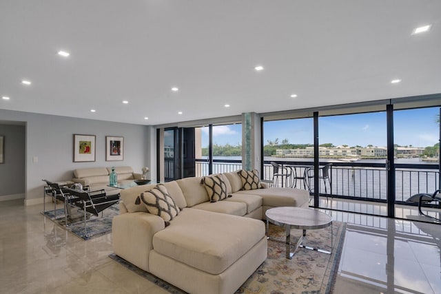 living room with a water view and floor to ceiling windows