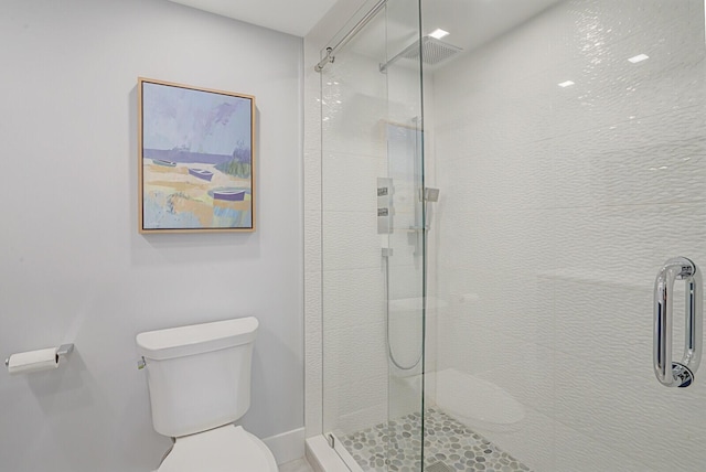 bathroom featuring toilet and walk in shower