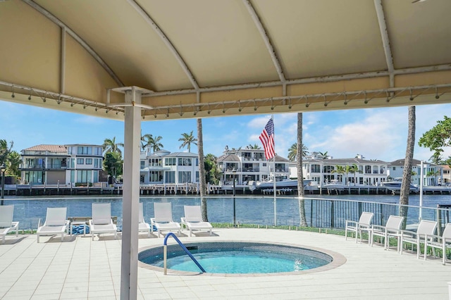 view of swimming pool with a community hot tub and a water view