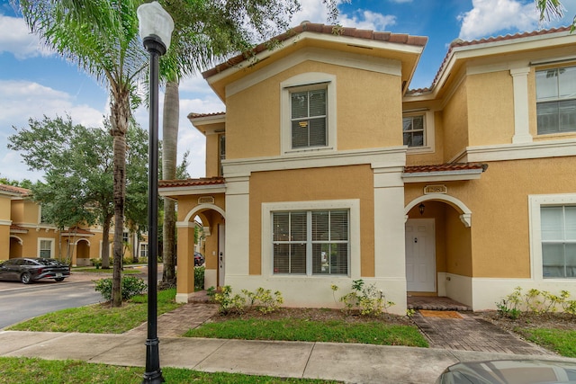 view of front of property with a tile roof and stucco siding