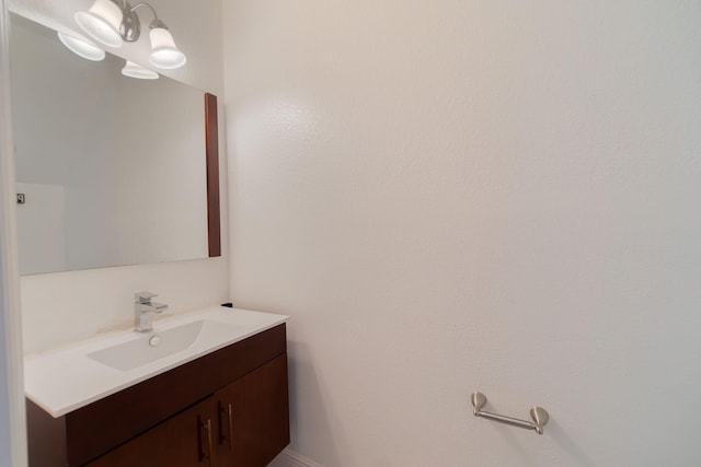 bathroom featuring vanity and a chandelier