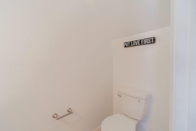 bathroom with toilet and baseboards