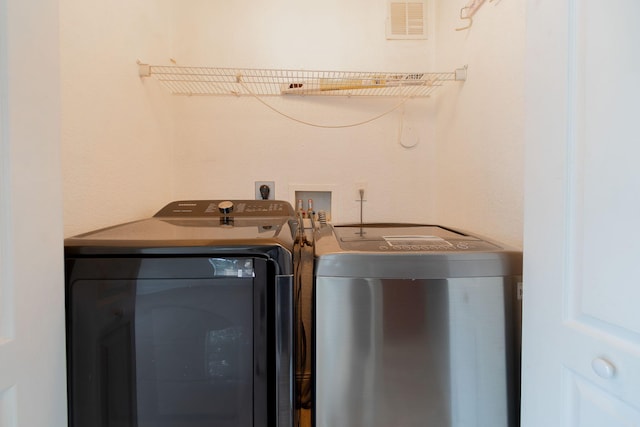 laundry room with laundry area, independent washer and dryer, and visible vents