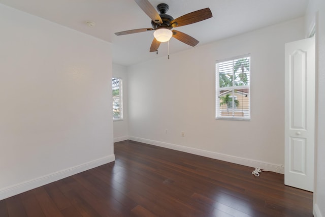 unfurnished room with dark wood-type flooring, baseboards, and ceiling fan