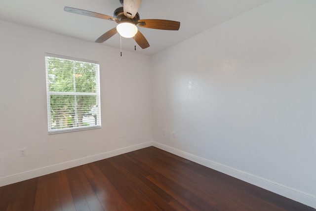 unfurnished room featuring baseboards, a ceiling fan, and dark wood-type flooring