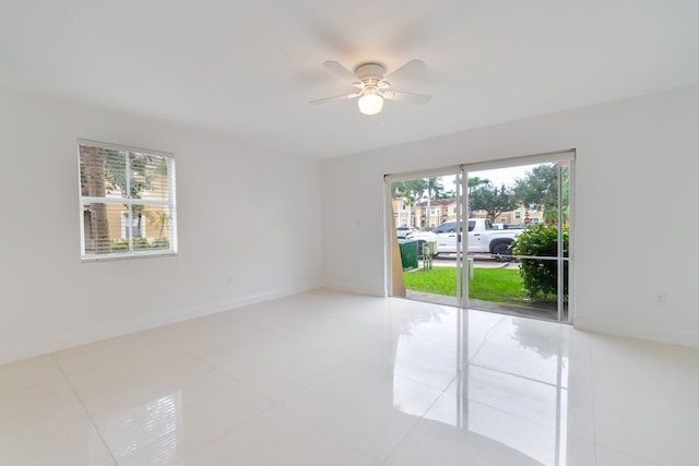 unfurnished room featuring baseboards, ceiling fan, and tile patterned flooring