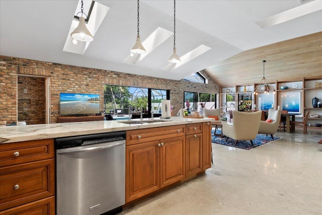 kitchen featuring hanging light fixtures, stainless steel dishwasher, brick wall, and vaulted ceiling with skylight