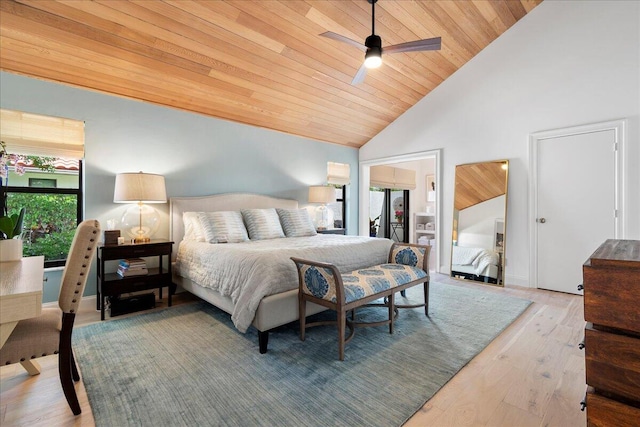 bedroom featuring ceiling fan, light hardwood / wood-style floors, high vaulted ceiling, and multiple windows