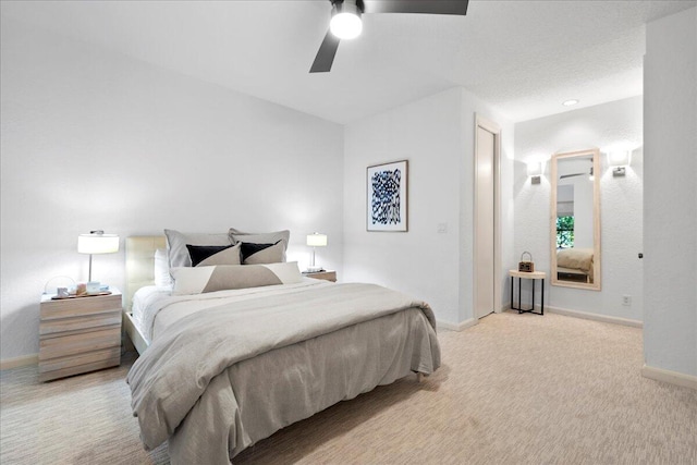 bedroom featuring ceiling fan and light colored carpet