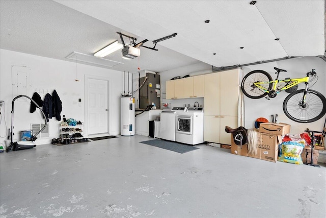 garage with washing machine and dryer, heating unit, a garage door opener, and water heater