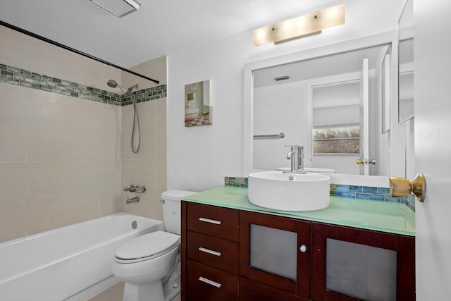 full bathroom with vanity, tiled shower / bath combo, and toilet