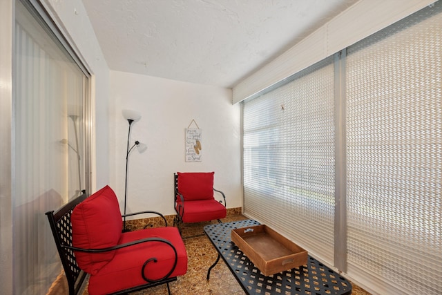 living area featuring a textured ceiling