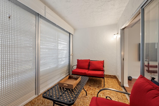 living area featuring a textured ceiling