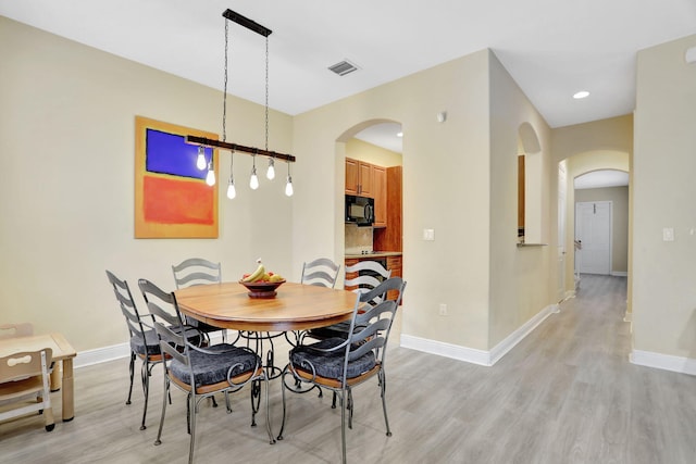 dining area with light hardwood / wood-style flooring