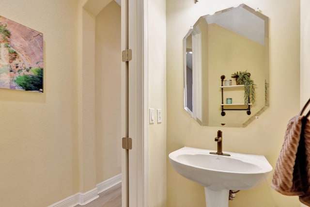 bathroom with hardwood / wood-style flooring and sink